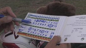 showing a paper scorecard